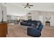 Open-concept living room with views of the kitchen and dining area, and a large sectional at 1137 Stratton Ave, Groveland, FL 34736