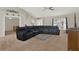 Bright and airy living room with a large sectional, pendant light, and a view of the foyer at 1137 Stratton Ave, Groveland, FL 34736