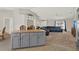 View from kitchen island to spacious living room with neutral color palette and comfortable seating at 1137 Stratton Ave, Groveland, FL 34736