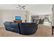 Spacious living room featuring vaulted ceilings, a ceiling fan, and a view of the kitchen at 1137 Stratton Ave, Groveland, FL 34736