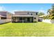Well maintained backyard featuring green grass, a screened patio and a privacy fence at 11926 Verrazano Dr, Orlando, FL 32836