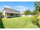 Expansive backyard with a screened lanai, lush green grass and privacy fence for outdoor enjoyment at 11926 Verrazano Dr, Orlando, FL 32836