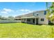 An ample green backyard with a screened lanai and privacy fence, perfect for entertaining at 11926 Verrazano Dr, Orlando, FL 32836