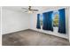 Bedroom with ceiling fan and natural light coming through window with blue curtains at 11926 Verrazano Dr, Orlando, FL 32836
