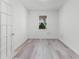 Bright bedroom with wood-look floors, white walls, and natural light at 11926 Verrazano Dr, Orlando, FL 32836
