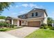 Beautiful two-story home featuring a two-car garage, brick driveway and lush landscaping at 11926 Verrazano Dr, Orlando, FL 32836