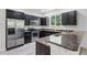 Gourmet kitchen features stainless steel appliances, granite countertops, and dark wood cabinetry for a sleek, modern look at 11926 Verrazano Dr, Orlando, FL 32836