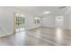 Bright living room has large windows and a sliding glass door offering great views of the backyard and patio at 11926 Verrazano Dr, Orlando, FL 32836