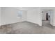 Spacious main bedroom featuring neutral carpet, white walls and an entrance to an ensuite bathroom at 11926 Verrazano Dr, Orlando, FL 32836