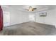 Spacious main bedroom featuring neutral carpet, white walls, an ensuite bath, walk-in closet and a television at 11926 Verrazano Dr, Orlando, FL 32836