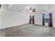 Spacious main bedroom featuring neutral carpet, white walls and a stylish ceiling fan at 11926 Verrazano Dr, Orlando, FL 32836