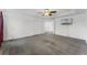 Spacious main bedroom featuring neutral carpet, white walls, an ensuite bath, walk-in closet and a television at 11926 Verrazano Dr, Orlando, FL 32836