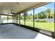 The screened-in lanai offers views of a well maintained lawn and tropical foliage at 11926 Verrazano Dr, Orlando, FL 32836