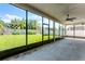 A screened in lanai overlooking a lush, well-manicured backyard at 11926 Verrazano Dr, Orlando, FL 32836