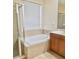Bathroom featuring a soaking tub, glass shower, and vanity with storage at 12863 Holdenbury Ln, Windermere, FL 34786