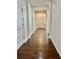 Hallway with hardwood floors, white trim, and arched doorways at 12863 Holdenbury Ln, Windermere, FL 34786