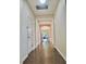 Hallway with hardwood floors leading to the home's entrance at 12863 Holdenbury Ln, Windermere, FL 34786