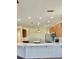 Stylish kitchen featuring island, stainless steel appliances, white countertop, and ample lighting at 12863 Holdenbury Ln, Windermere, FL 34786