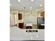 Open-concept kitchen with stainless steel appliances, island, and white countertop, perfect for entertaining at 12863 Holdenbury Ln, Windermere, FL 34786