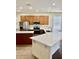 Well-equipped kitchen with island, stainless steel appliances, and white countertop, creating a modern aesthetic at 12863 Holdenbury Ln, Windermere, FL 34786