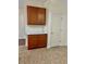 Kitchenette area boasts ample storage with wooden cabinets, white countertop and tile flooring at 12863 Holdenbury Ln, Windermere, FL 34786