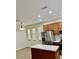 Modern kitchen showcasing stainless steel appliances, island with white countertop, and stylish lighting at 12863 Holdenbury Ln, Windermere, FL 34786