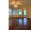 Spacious living room with hardwood floors and sliding glass doors at 12863 Holdenbury Ln, Windermere, FL 34786