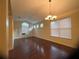 Spacious living room featuring hardwood floors, vaulted ceiling, and abundant natural light from multiple windows at 12863 Holdenbury Ln, Windermere, FL 34786