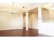 Spacious living room with hardwood floors, archways, and modern lighting fixtures at 12863 Holdenbury Ln, Windermere, FL 34786