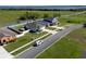 This aerial view highlights a home near a lake, showcasing curb appeal and a well-maintained community at 13233 Lake Yale View Loop, Grand Island, FL 32735
