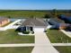 Aerial view of a charming single-Gathering home featuring a well-manicured lawn and a two-car garage at 13233 Lake Yale View Loop, Grand Island, FL 32735
