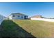 Large backyard with well-kept lawn, perfect for recreation and privacy with its surrounding fence at 13233 Lake Yale View Loop, Grand Island, FL 32735