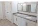 Bathroom featuring double sinks, modern vanity and a large mirror at 13233 Lake Yale View Loop, Grand Island, FL 32735