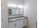 Bathroom featuring double sinks, modern vanity and a large mirror at 13233 Lake Yale View Loop, Grand Island, FL 32735