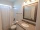 A bright bathroom featuring a shower-tub, white tiling, updated vanity, and a large framed mirror at 13233 Lake Yale View Loop, Grand Island, FL 32735