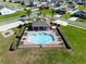 Aerial view highlighting a community pool with a covered pavilion and ample seating areas for residents at 13233 Lake Yale View Loop, Grand Island, FL 32735