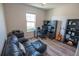 This home office features wood floors, a black leather couch, and a modern black desk and shelving system at 13233 Lake Yale View Loop, Grand Island, FL 32735