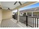 Spacious balcony with wooden deck, fan and metal railing offering views of the neighborhood at 1341 Mill Stream Ln, Winter Springs, FL 32708