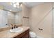 Bathroom boasts a single vanity, decorative mirror, and a shower with neutral tile accents at 1341 Mill Stream Ln, Winter Springs, FL 32708