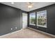 Carpeted bedroom with a ceiling fan, natural light from two windows, and neutral colored walls at 1341 Mill Stream Ln, Winter Springs, FL 32708