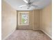 Bright bedroom features a cozy window seat, neutral carpeting, and a ceiling fan at 1341 Mill Stream Ln, Winter Springs, FL 32708