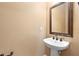 Pedestal sink and framed mirror in a half bath creating a simple and clean space at 1341 Mill Stream Ln, Winter Springs, FL 32708