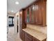 Hallway with dark wood cabinets, light granite countertops, and access to other rooms, offering style and functionality at 1341 Mill Stream Ln, Winter Springs, FL 32708