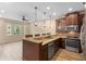 Open kitchen with granite countertops, stainless appliances, and bar seating at 1341 Mill Stream Ln, Winter Springs, FL 32708