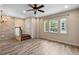 Bright living room featuring hardwood floors, staircase, and large windows at 1341 Mill Stream Ln, Winter Springs, FL 32708