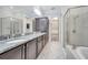 Large bathroom featuring granite countertops, dual sinks, a walk in closet, and a walk-in shower at 13852 Maskawa Ave, Orlando, FL 32827