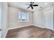 Bedroom with a ceiling fan, neutral walls, and a window, with wood-look floors at 13852 Maskawa Ave, Orlando, FL 32827