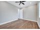 A spacious bedroom featuring a ceiling fan, bright window, and durable wood-look flooring at 13852 Maskawa Ave, Orlando, FL 32827