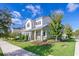 Beautiful two-story home featuring a cozy porch and well-maintained lawn at 13852 Maskawa Ave, Orlando, FL 32827