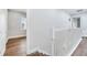 Upstairs hallway with wood floors and white trim, creating a bright and inviting space at 13852 Maskawa Ave, Orlando, FL 32827